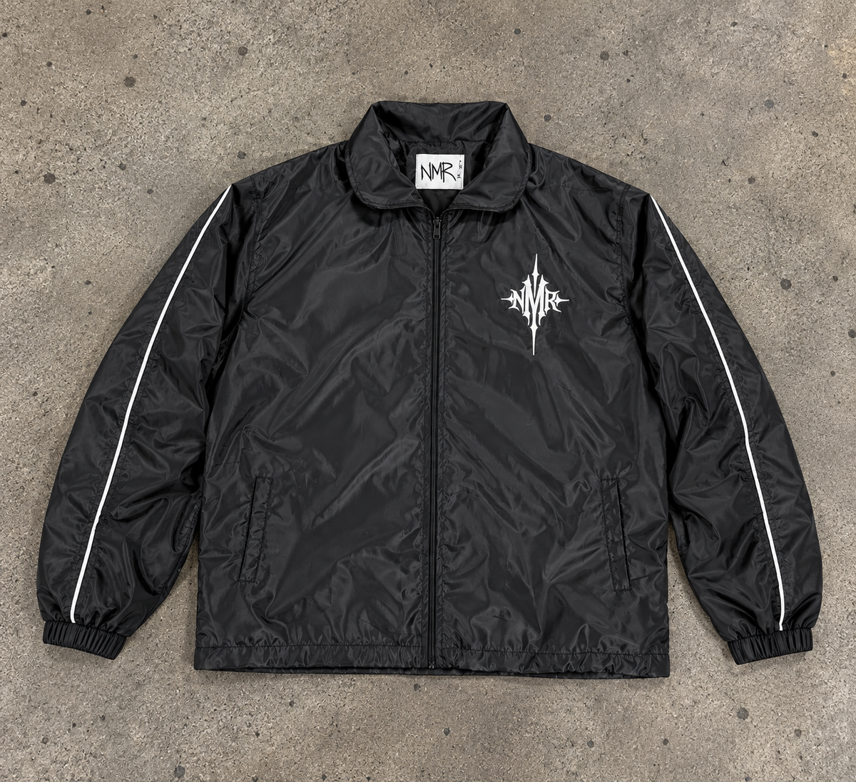 Black NMR nylon jacket on concrete background